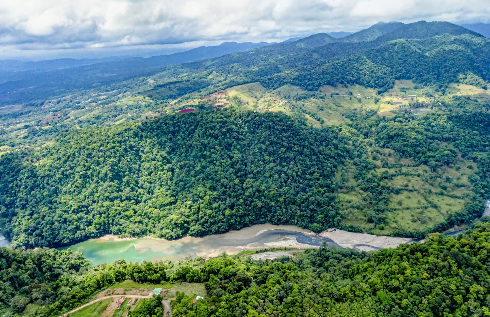 A river winding through a forested valley in San Carlos